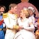 The Prince and Cinderella are surrounded by her evil stepmother and stepsisters and Fairy Godmother